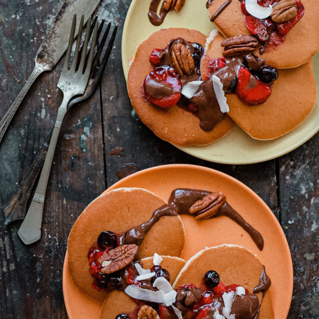 Protein Pancakes topped with berries on a table