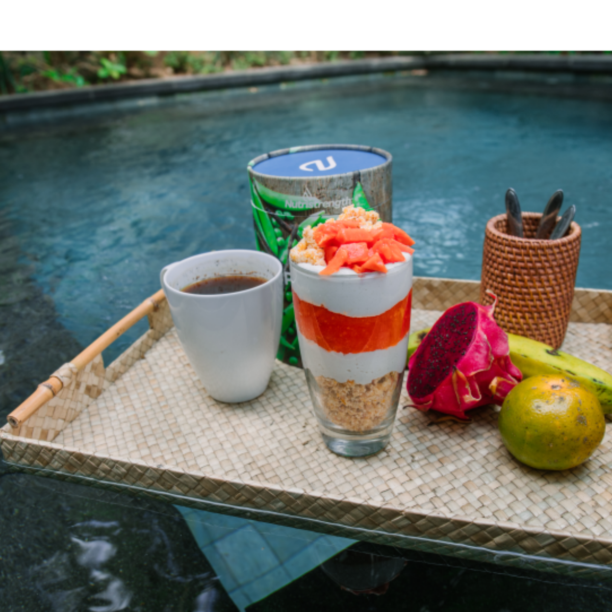 classic vanilla pea protein supplement on tray by pool and tropical fruit | Nutristrength